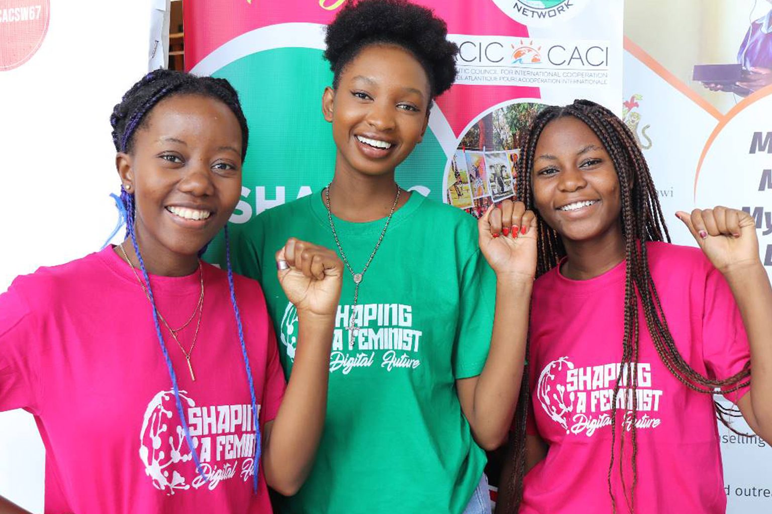 Young women from GENET's movement raising their fists