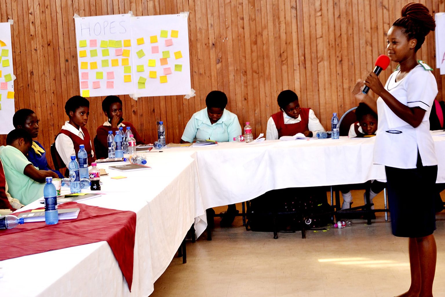 A role model speaking to girls at a leadership training